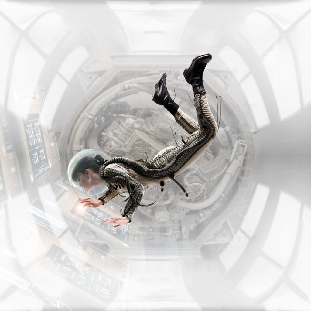 Weightless In Space Station - Female astronaut floating while working in space station