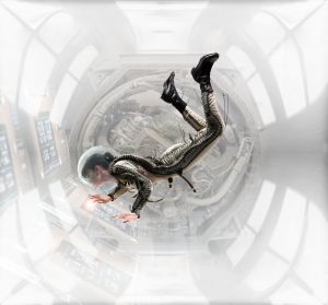 Weightless In Space Station - Female astronaut floating while working in space station