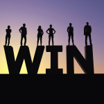 6 athletes stand on top of a black silhouette spelling out "Win" in front of a sunset. The athletes appear to be men and women.